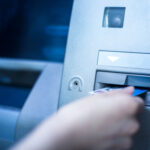 Woman using cash machine-ATM,close up view