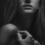 woman touching her shoulders